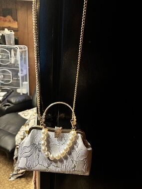 Beautiful brand new purse with removable hardware color is a light purple